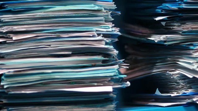 Stacks of old documents in the old archive. Brown, old data files.