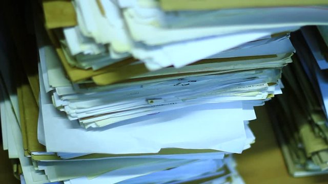 Stacks of old documents in the old archive. Brown, old data files.