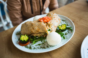 Female food blogger taking photos for their food blog using mobile phones
