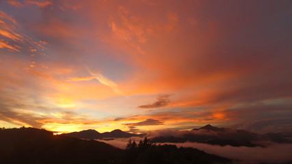 Day ends in the mountains with bold sunset.