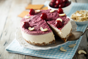 Raw vegan cheesecake with cherry and cashew nuts