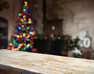 Empty table in front of christmas tree with decorations background. For product display montage.