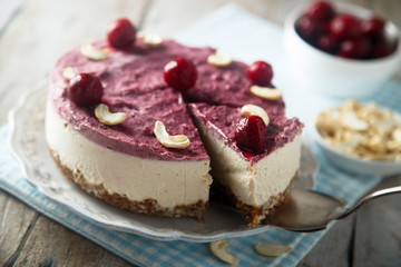 Raw vegan cheesecake with cherry and cashew nuts