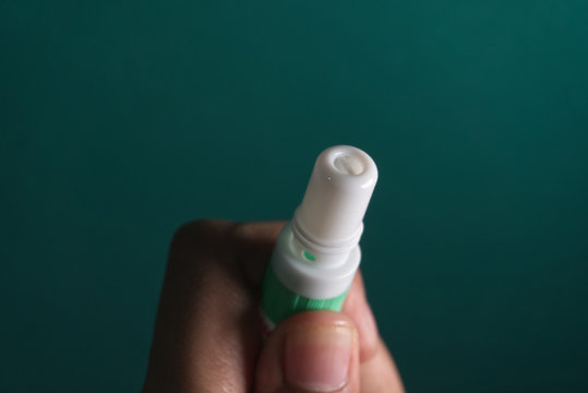 hand holding thai medical inhalant smelling salt.