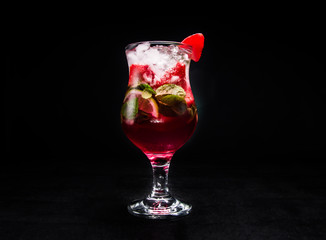 Berry Mojito with lime, mint, ice and strawberries. beautiful cocktail on an isolated black background.