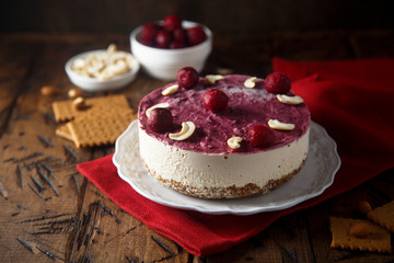 Raw vegan cheesecake with cherry and cashew nuts