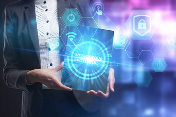 Business, Technology, Internet and network concept. Young businessman working on a virtual screen of the future and sees the inscription: Unlock your potential