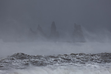 View from Vik beach during heavy storm, Iceland. Splashing waves in the foreground.