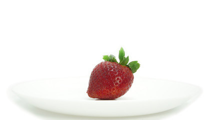Large, ripe strawberries. Isolated. Juicy dessert, healthy vegetarian food. Bright, colorful breakfast. Strawberries on a white plate, isolated background. Organic, natural food.