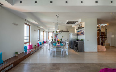 Interior of kitchen in modern studio apartment. Kitchen set and laid table. Private house.