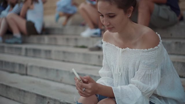 Girl spending free time surfing on smartphone