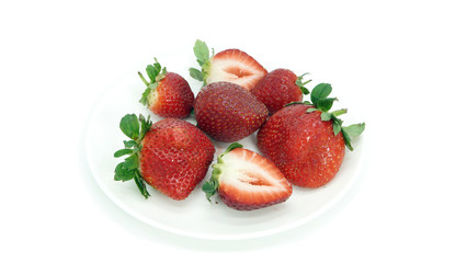 Large, ripe strawberries. Isolated. Juicy dessert, healthy vegetarian food. Bright, colorful breakfast. Strawberries on a white plate, isolated background. Organic, natural food.