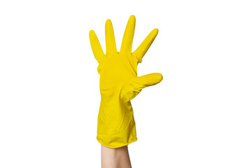 A female hand in a yellow rubber glove for cleaning shows a gesture on a white isolated background. Five fingers