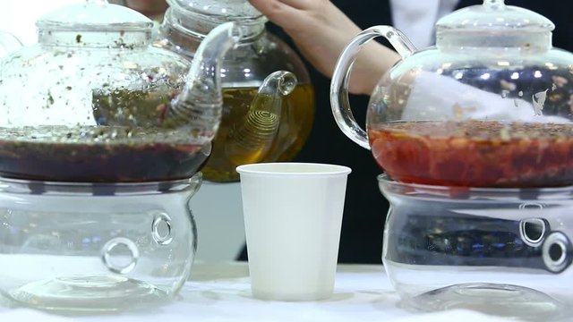 Pouring tea into a paper Cup