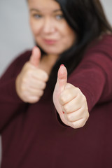 Woman making thumb up gesture