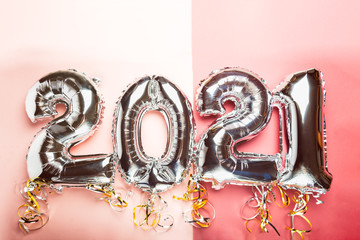 Balloon Bunting for celebration of New Year 2021 made from Silver Number Balloons. Holiday Party Decoration or postcard concept with top view and copy space.