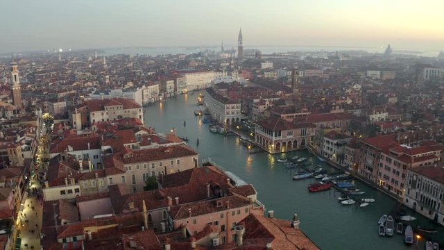 Aerial, drone shot panning towards the canal Grande, the Canalasso, on a sunny evening, in Venice city, Italy