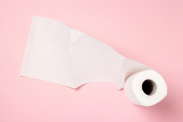 Roll of paper towels on a pink background. Concept is 100 natural product, delicate and soft. Flat lay, top view. Banner