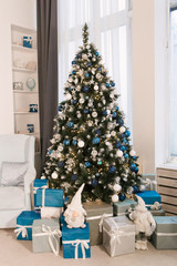 Christmas tree and other holiday decorations in white loft