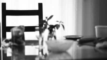 Interior with chairs, table and dishes. Out of focus.