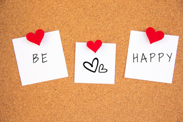 be happy red heart note on cork board