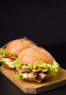 vegetarian mushroom sandwich close-up on a black background. There is a place for text. Vertical image