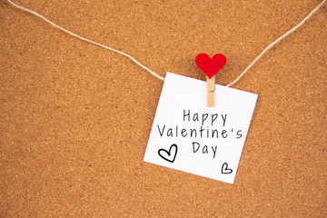Valentine 's day red heart note on cork board