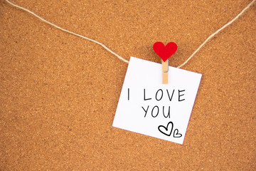 i love you red heart note on cork board