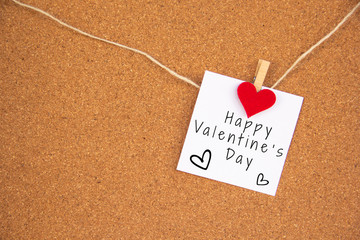 Valentine 's day red heart note on cork board