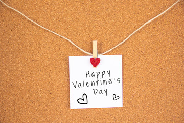 Valentine 's day red heart note on cork board