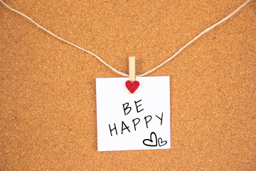 be happy red heart note on cork board