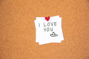 i love you red heart note on cork board