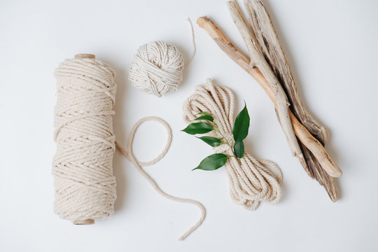 Cotton ropes and sticks from the river, grinded by water on a white surface