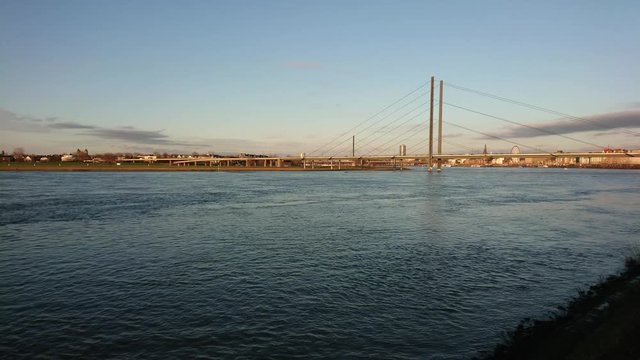 Timelapse of moving ferryboat on the big river with dark clouds in the sky