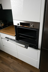 Cooking meal in electric oven in modern kitchen
