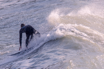 a surfer surf a wave in italy
