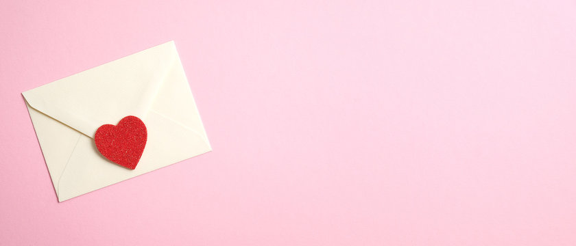 Happy Valentine's Day concept. Wide banner with romantic love letter and red heart on pink background. Flat lay, top view, copy space.