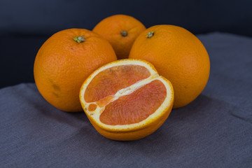 Cut Orange with three whole oranges