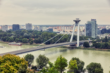 Fototapeta na wymiar SNP New Bridge through Danude river aerial panoramic view in Bratislava