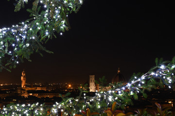 The Palazzo Vecchio in Florence as seen from Piazzale Michelangelo with the lights of Christmas tree on foreground. The Palazzo Vecchio "Old Palace" is the town hall of Florence, Italy.