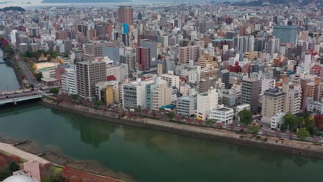 Aerial view of cityscape of Hiroshima, office buildings and skyscrapers of modern Japanese city - landscape panorama of Japan from above, Asia
