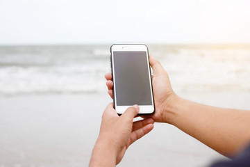 hand holding mobile phone with blank screen