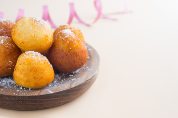 Carnival italian fritters in carnival on brown background