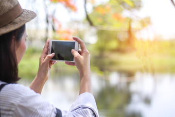 woman taking photo with mobile phone