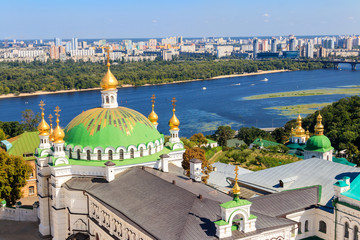 Fototapeta na wymiar View of the refectory church of Kiev Pechersk Lavra (Kiev Monastery of the Caves) and the Dnieper river in Ukraine. View from Great Lavra Bell Tower