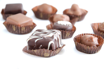 chocolate candies in a candy wrapper on a white background. A set of sweets with different tastes ..