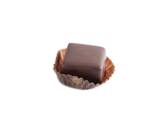 tasty, chocolate candy in a candy wrapper on a white background.