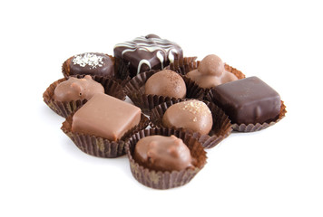 chocolate candies in a candy wrapper on a white background. A set of sweets with different tastes ..