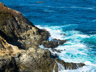 Splashing pacific ocean wave at Californian coast.