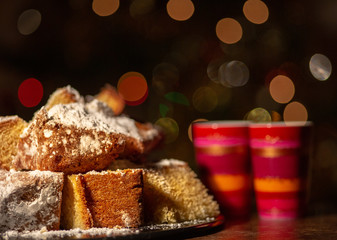Fototapeta na wymiar Pandoro slices and glasses in front of Christmas tree